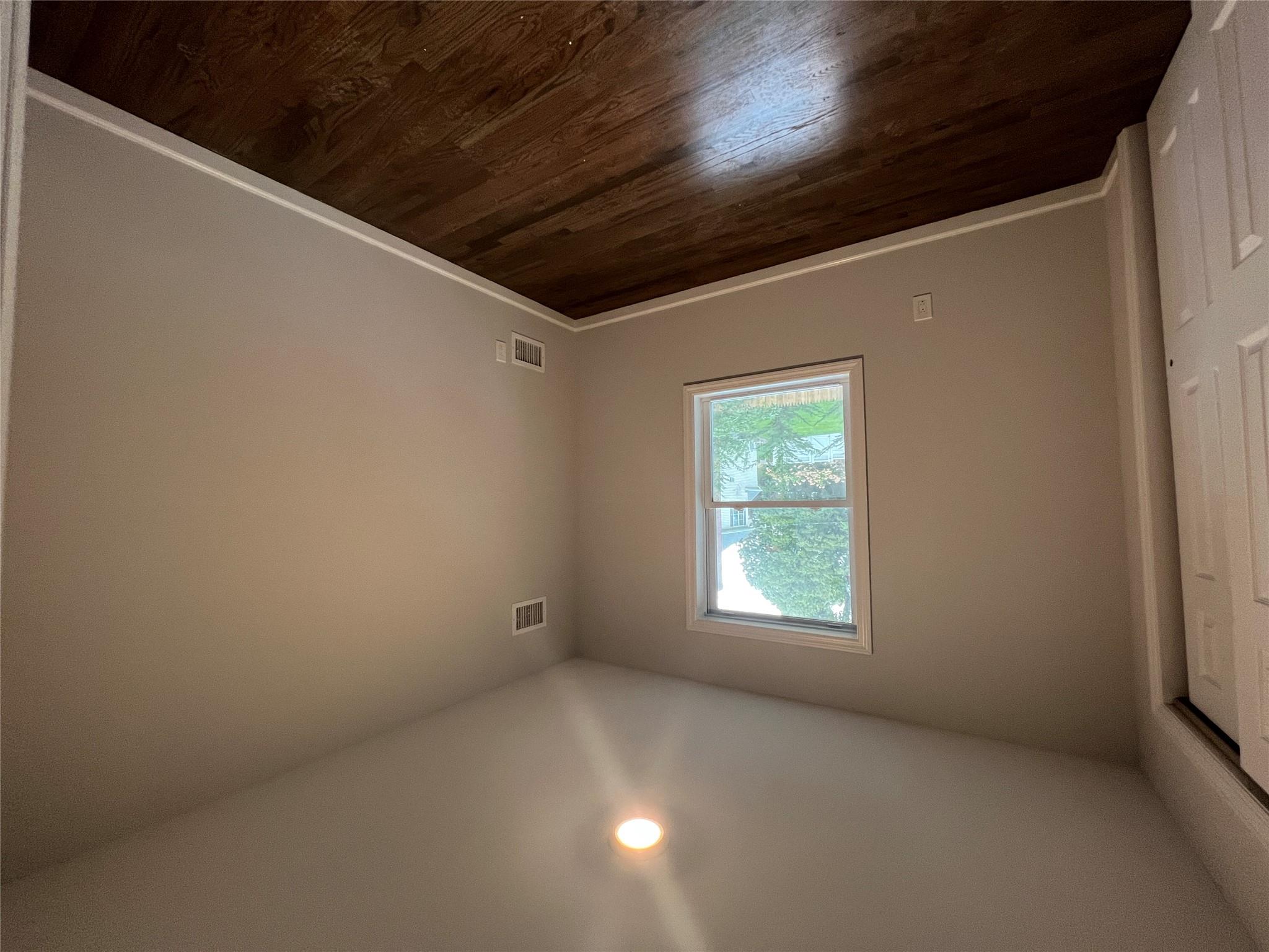N / C Blue Point Road Farmingville, NY 11738 - Photo 11 of 16 an empty room with wooden floor and windows