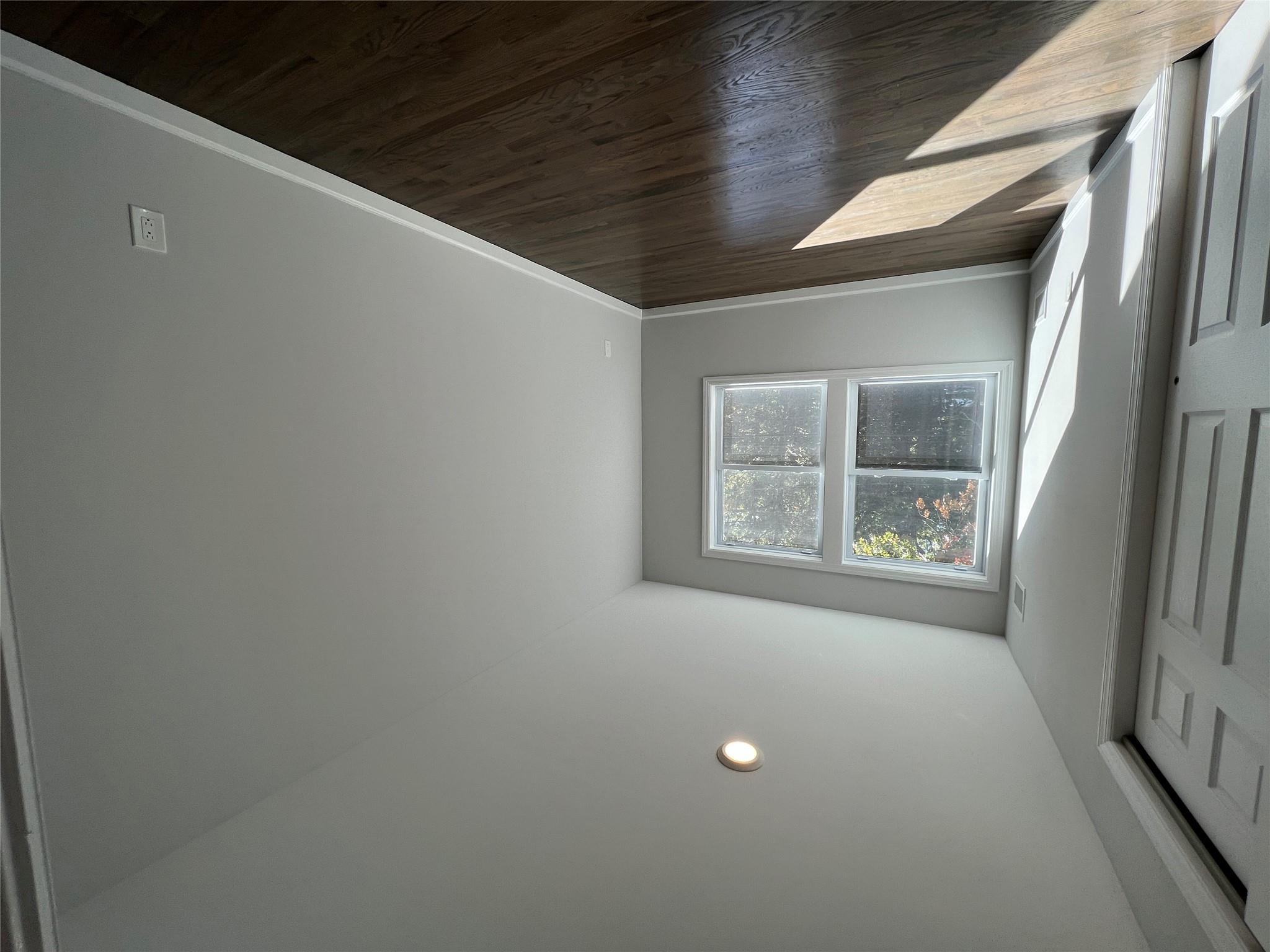 N / C Blue Point Road Farmingville, NY 11738 - Photo 12 of 16 an empty room with wooden floor and windows