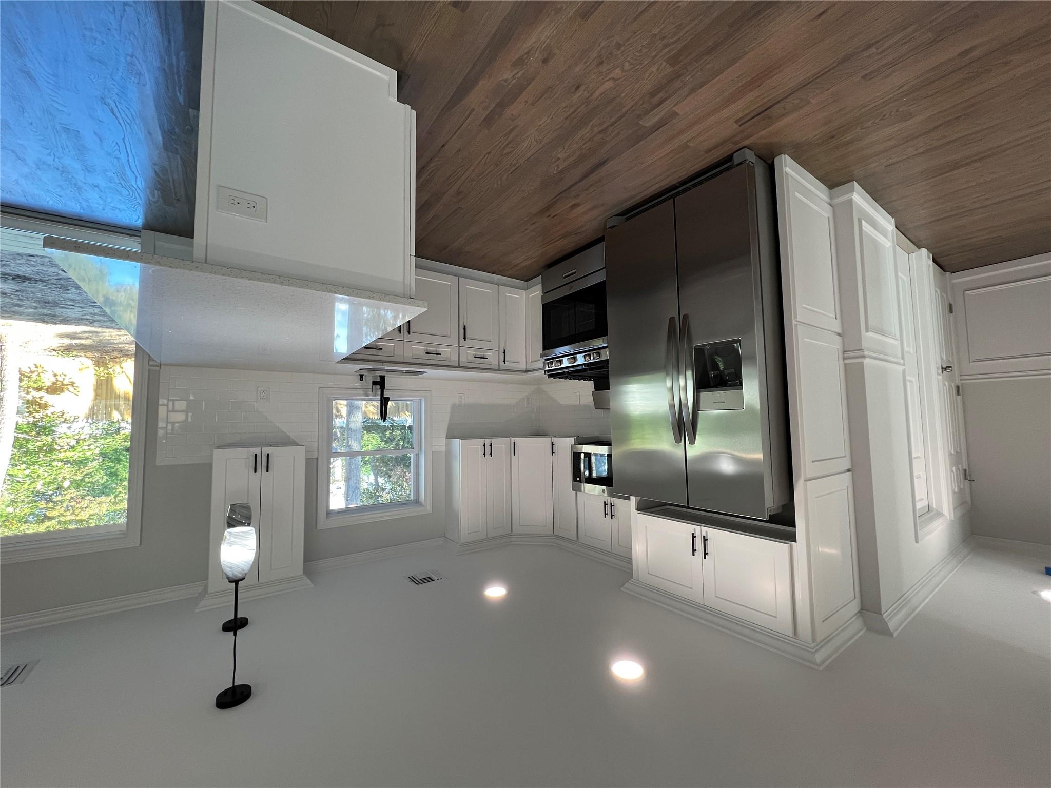 N / C Blue Point Road Farmingville, NY 11738 - Photo 8 of 16 a kitchen with stainless steel appliances granite countertop a refrigerator a sink a stove and cabinets