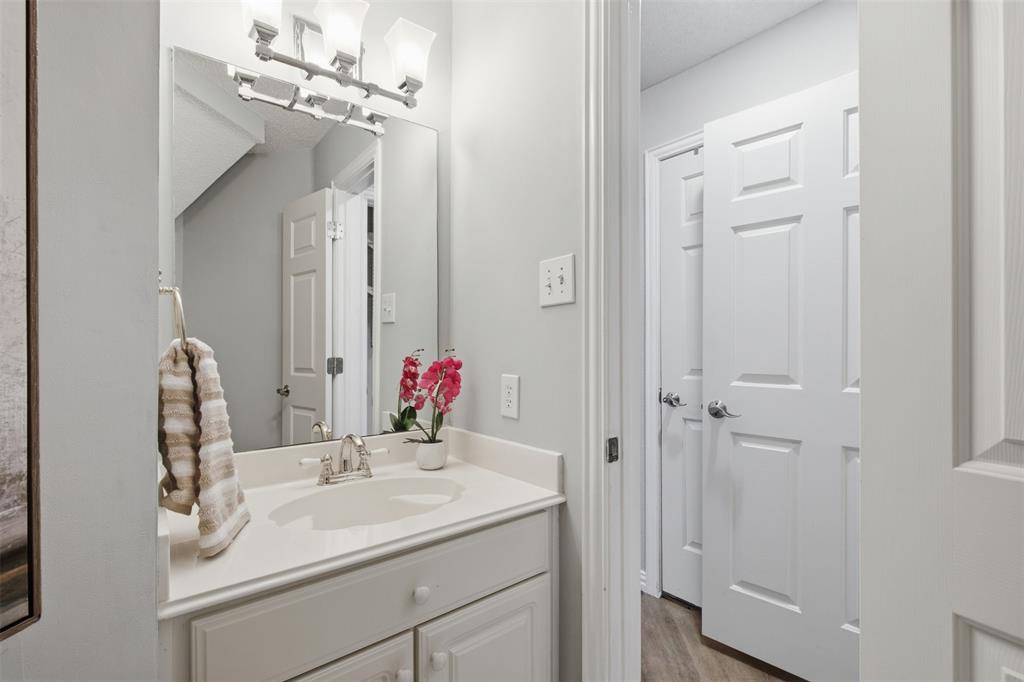 14584 Blueberry Court Addison, TX 75001 - Photo 19 of 40 a bathroom with a sink vanity and a mirror