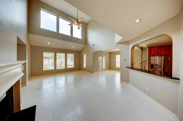 a view of an empty room with window and fireplace