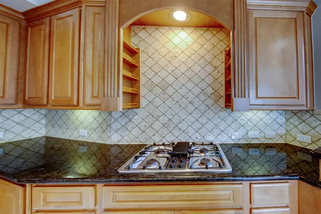 a kitchen with granite countertop a sink and a stove