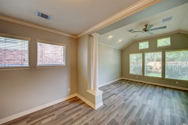 wooden floor in an empty room with a window