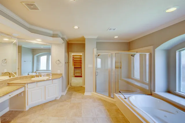 a large bathroom with a large tub shower sink and mirror