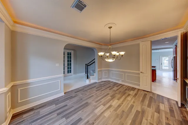a view of a livingroom with wooden floor a ceiling fan and window