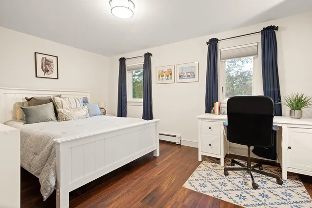 a bedroom with a bed and a desk