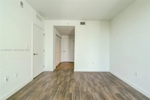 a view of a room with wooden floor