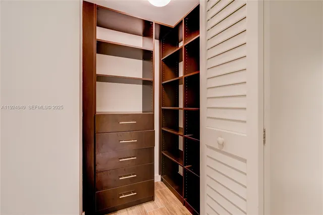 a view of walk in closet with empty racks