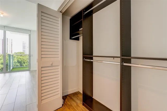 a view of closet with wooden floor