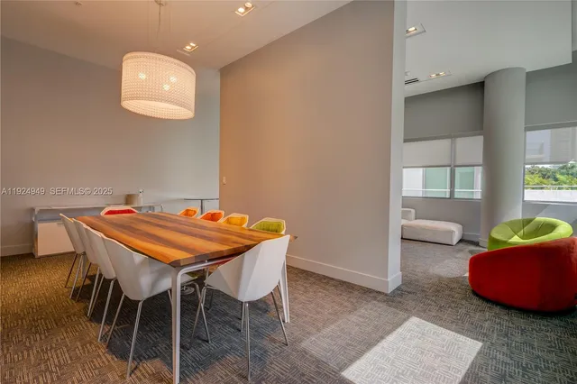 a dining room with furniture and a window