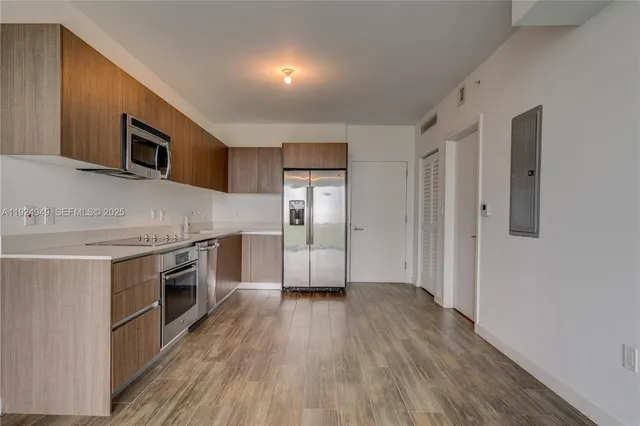a kitchen with granite countertop wooden floors and stainless steel appliances