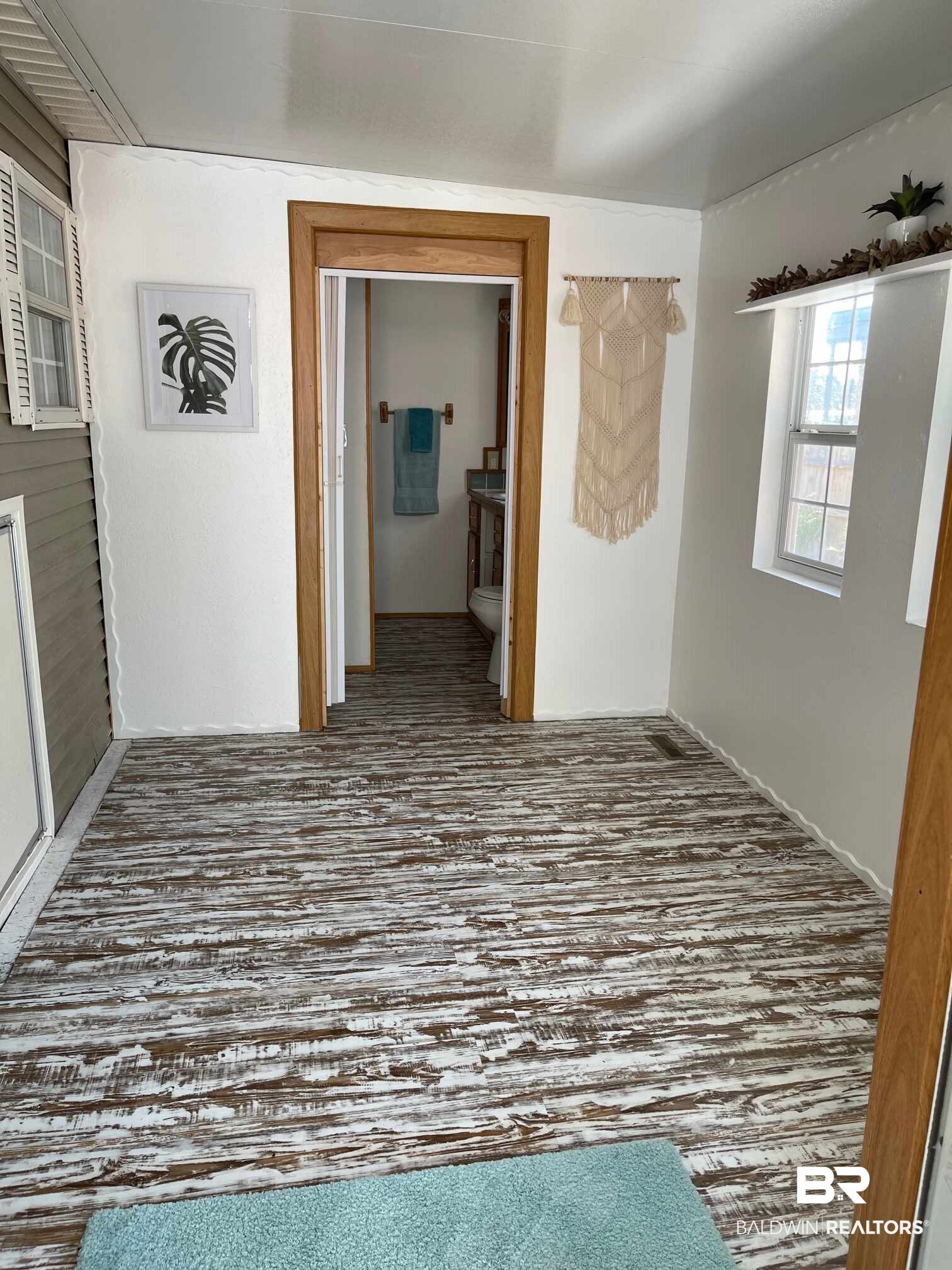 186 Defuniak Loop Lillian, AL 36549 - Photo 12 of 20 Wood-look flooring.