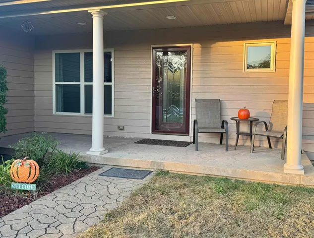 a backyard of a house with outdoor seating