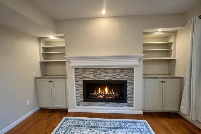 a living room with a fireplace and a rug