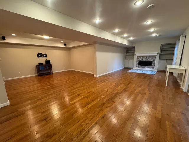 a view of a room with wooden floor