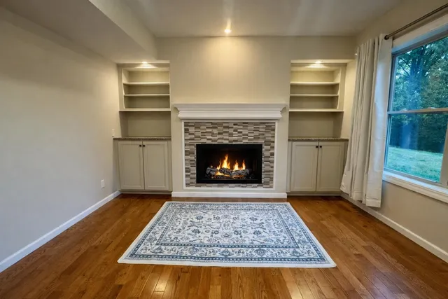 a view of a big room with wooden floor and fireplace