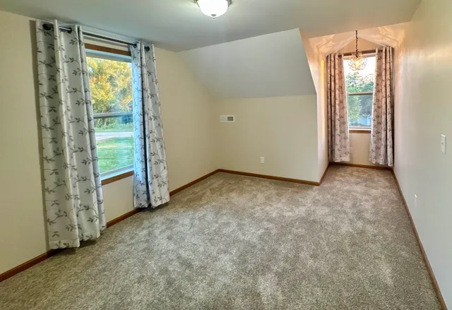 a view of a house with a yard and a garden
