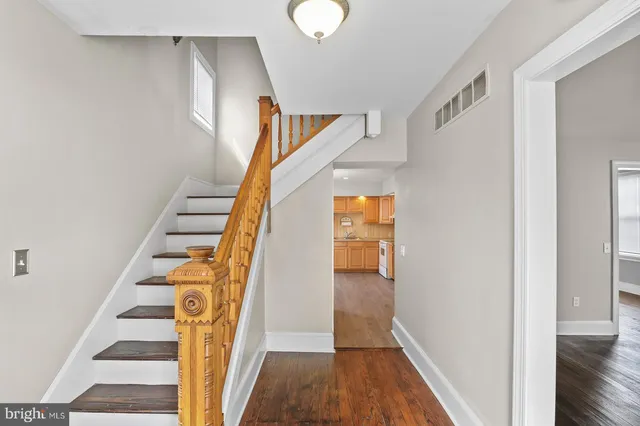a view of entryway and hall with wooden floor