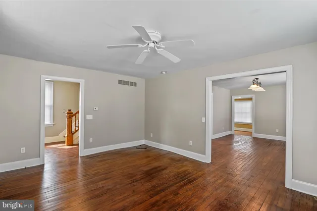 a view of an empty room and wooden floor