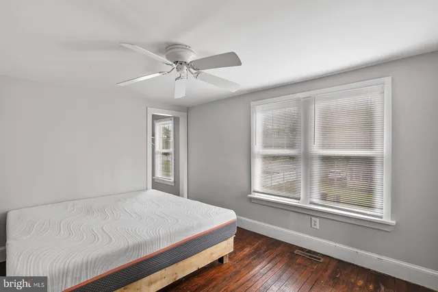 a bedroom with a large bed and a window