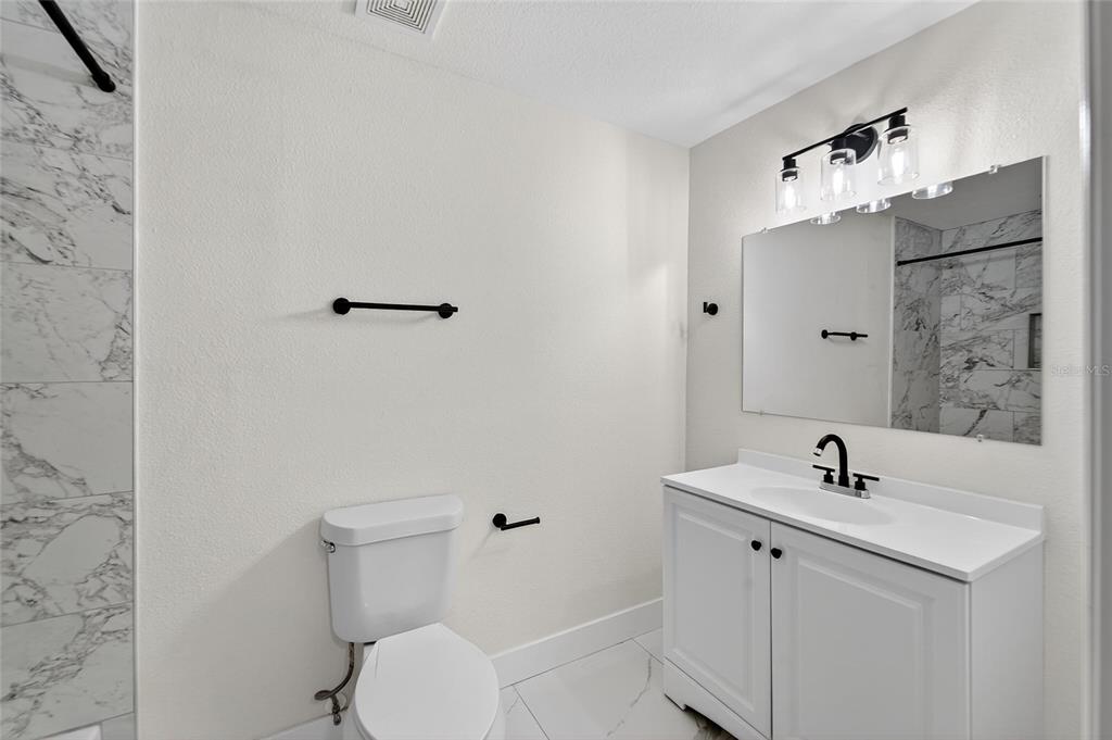 2525 West Beach Street Tampa, FL 33607 - Photo 14 of 48 a bathroom with a sink toilet and shower