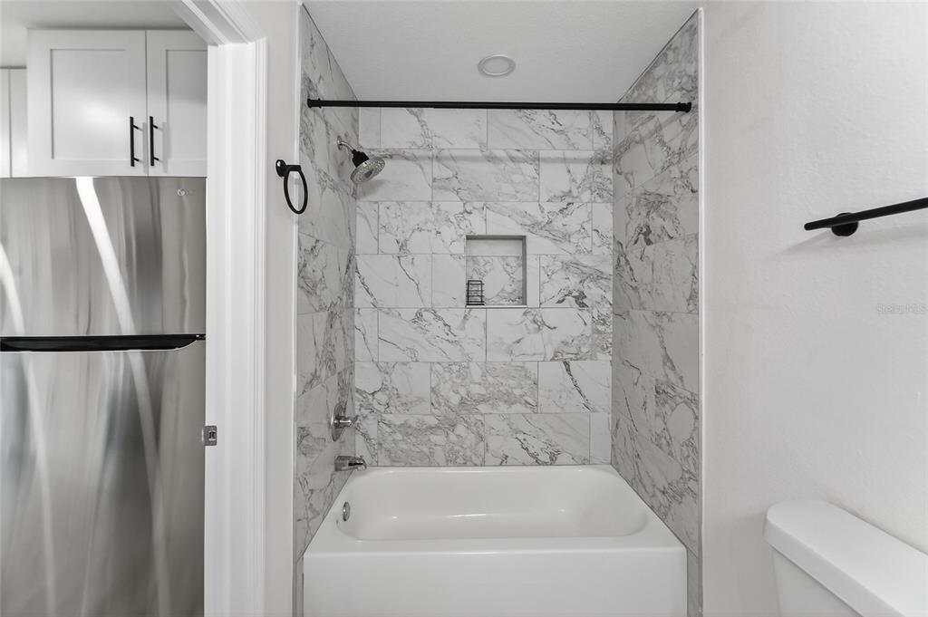 2525 West Beach Street Tampa, FL 33607 - Photo 15 of 48 a bathroom with a bathtub and a shower