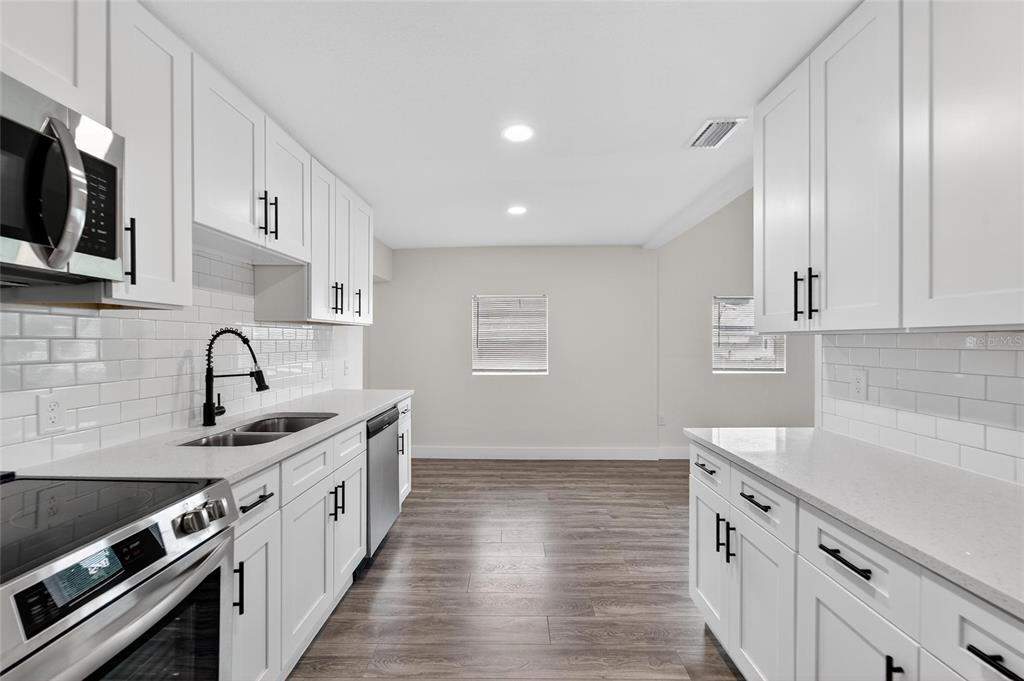 2525 West Beach Street Tampa, FL 33607 - Photo 16 of 48 a kitchen with stainless steel appliances granite countertop a sink stove and cabinets