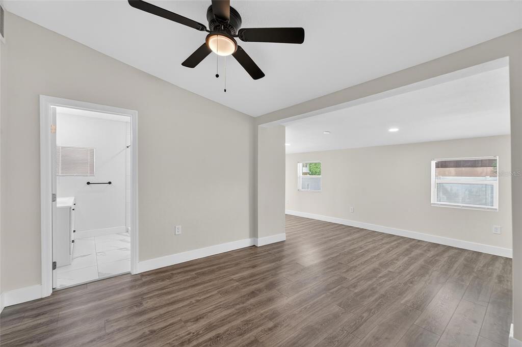 2525 West Beach Street Tampa, FL 33607 - Photo 31 of 48 an empty room with wooden floor ceiling fan and windows