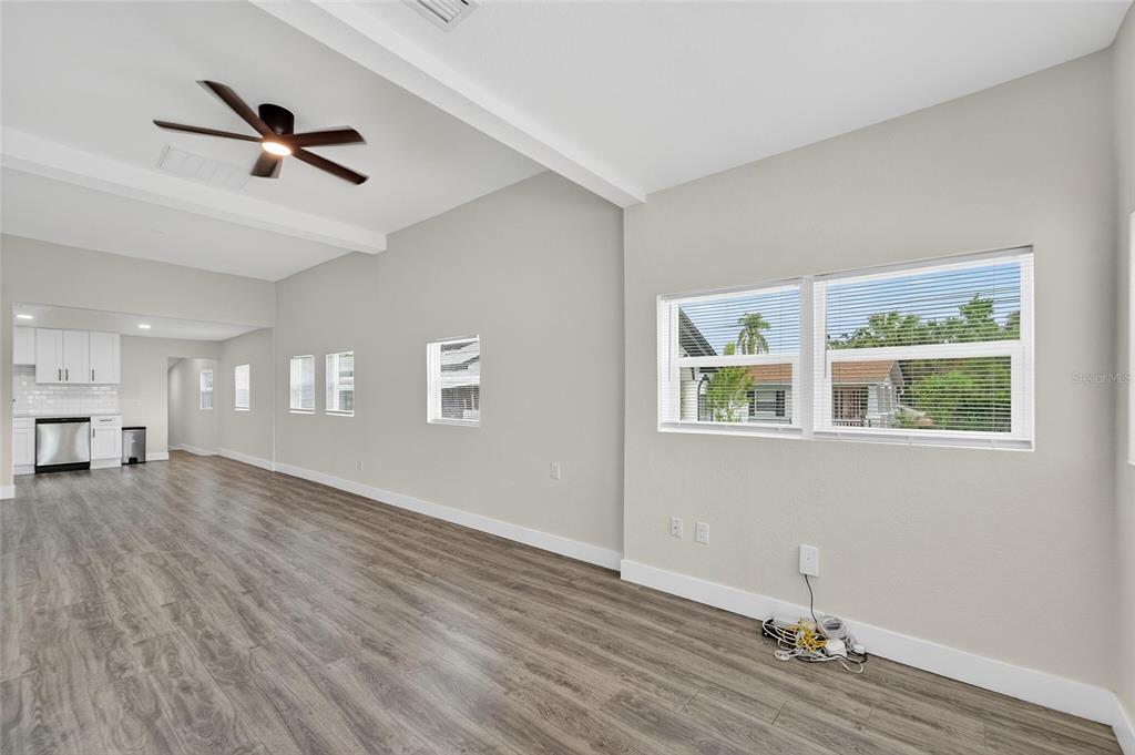 2525 West Beach Street Tampa, FL 33607 - Photo 4 of 48 a view of empty room with wooden floor and fan