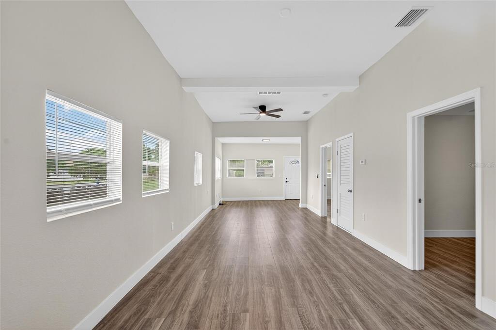 2525 West Beach Street Tampa, FL 33607 - Photo 8 of 48 a view of an empty room with wooden floor and a window