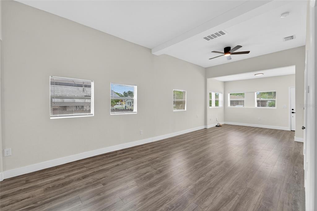 2525 West Beach Street Tampa, FL 33607 - Photo 9 of 48 a view of an empty room with wooden floor and a window