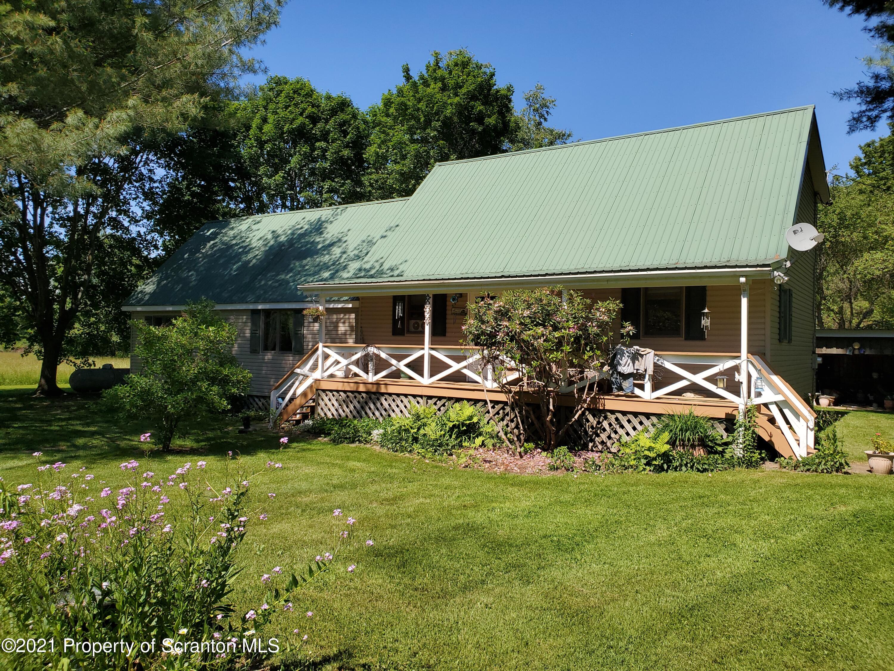 1280 Mitchell Road Montrose, PA 18801 - Photo 1 of 28 a view of a house with backyard and sitting area