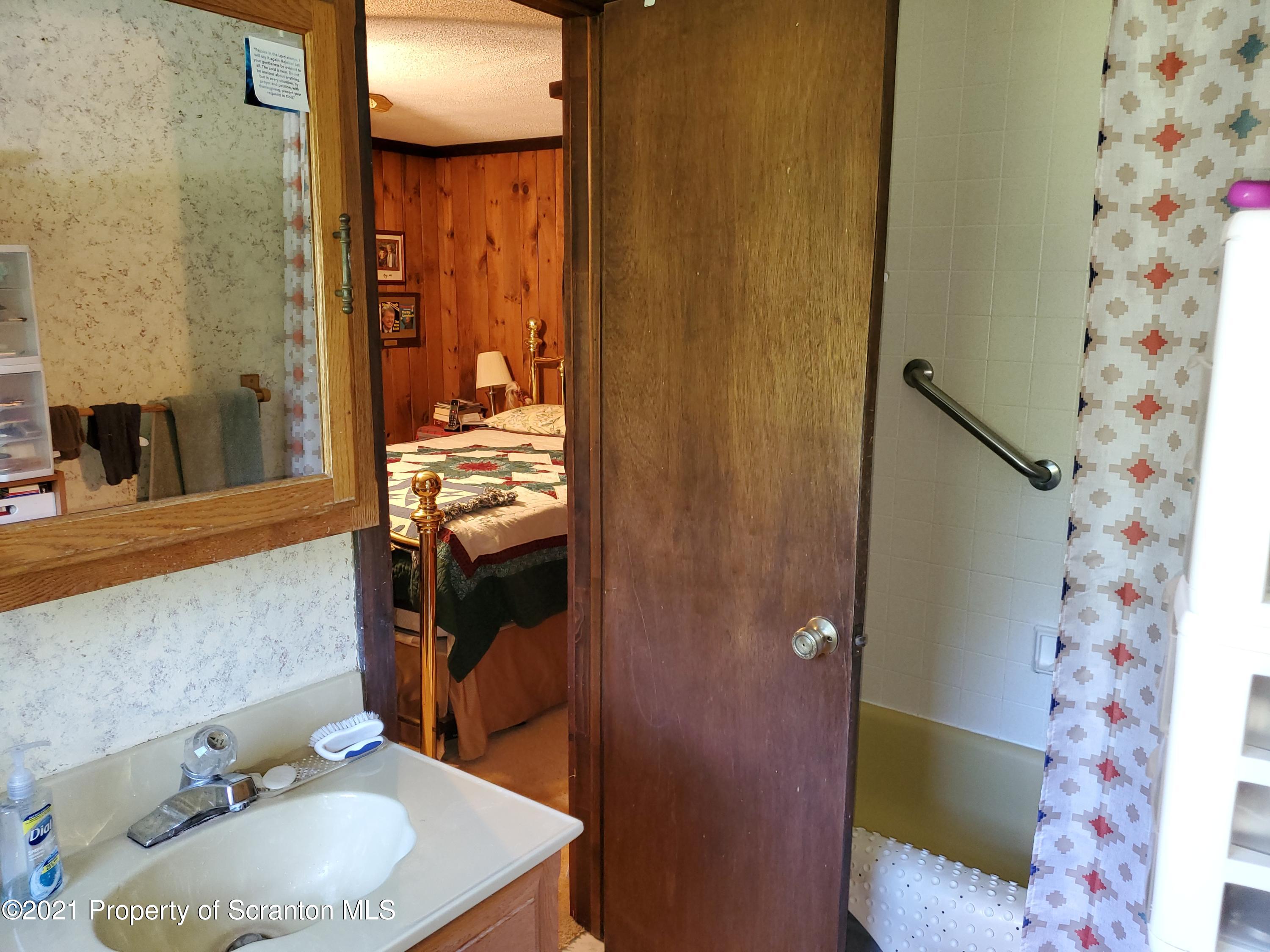 1280 Mitchell Road Montrose, PA 18801 - Photo 14 of 28 a bathroom with a sink and a mirror