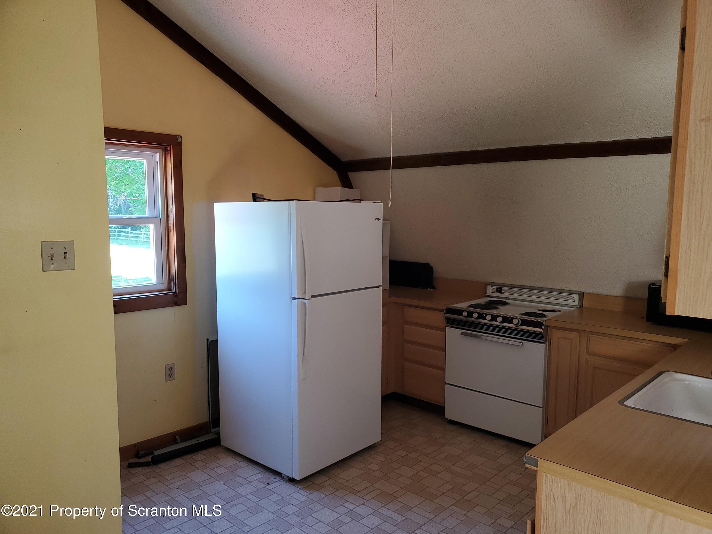 1280 Mitchell Road Montrose, PA 18801 - Photo 18 of 28 a kitchen with a refrigerator stove and sink