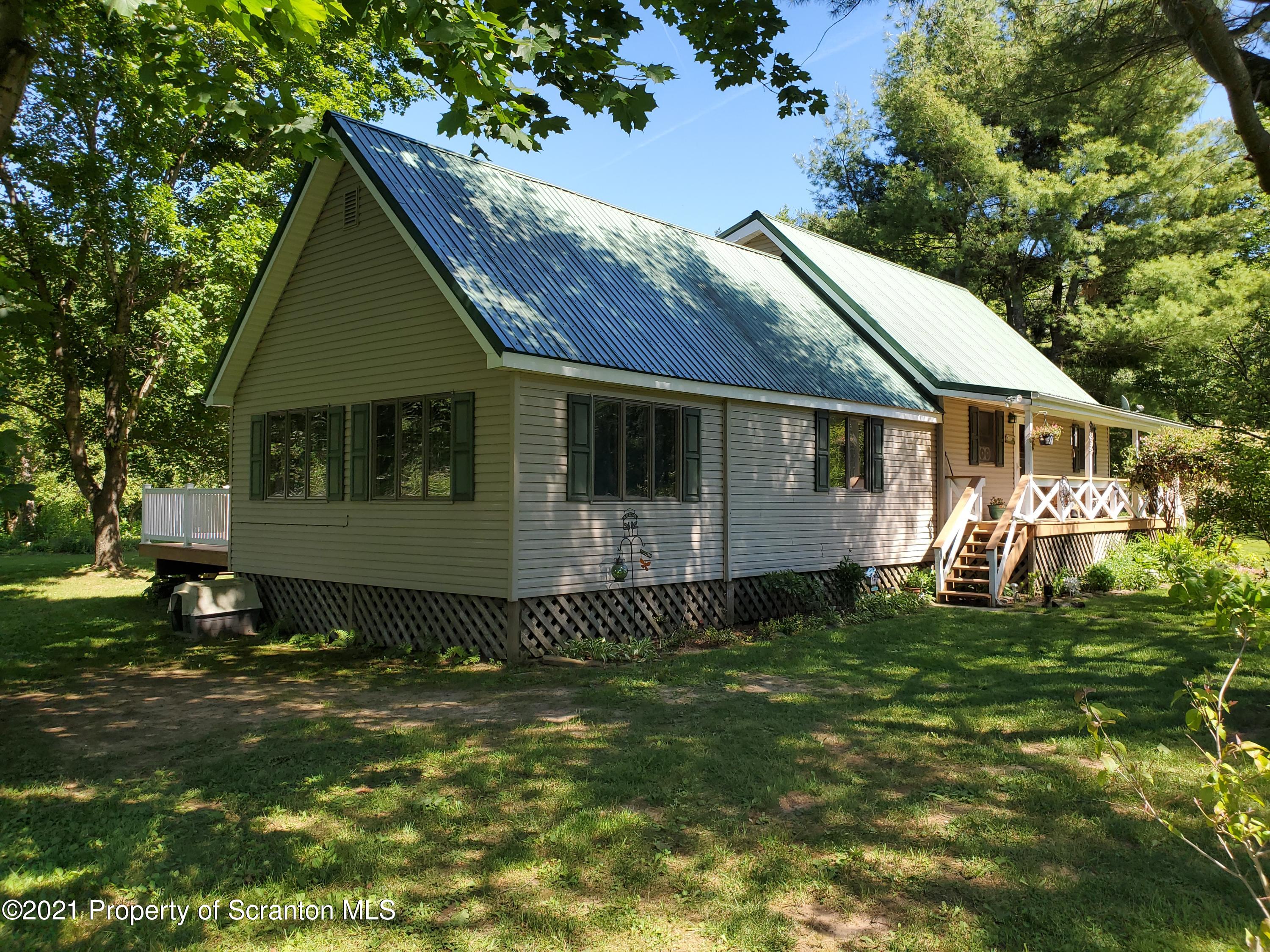 1280 Mitchell Road Montrose, PA 18801 - Photo 2 of 28 a front view of a house with a garden