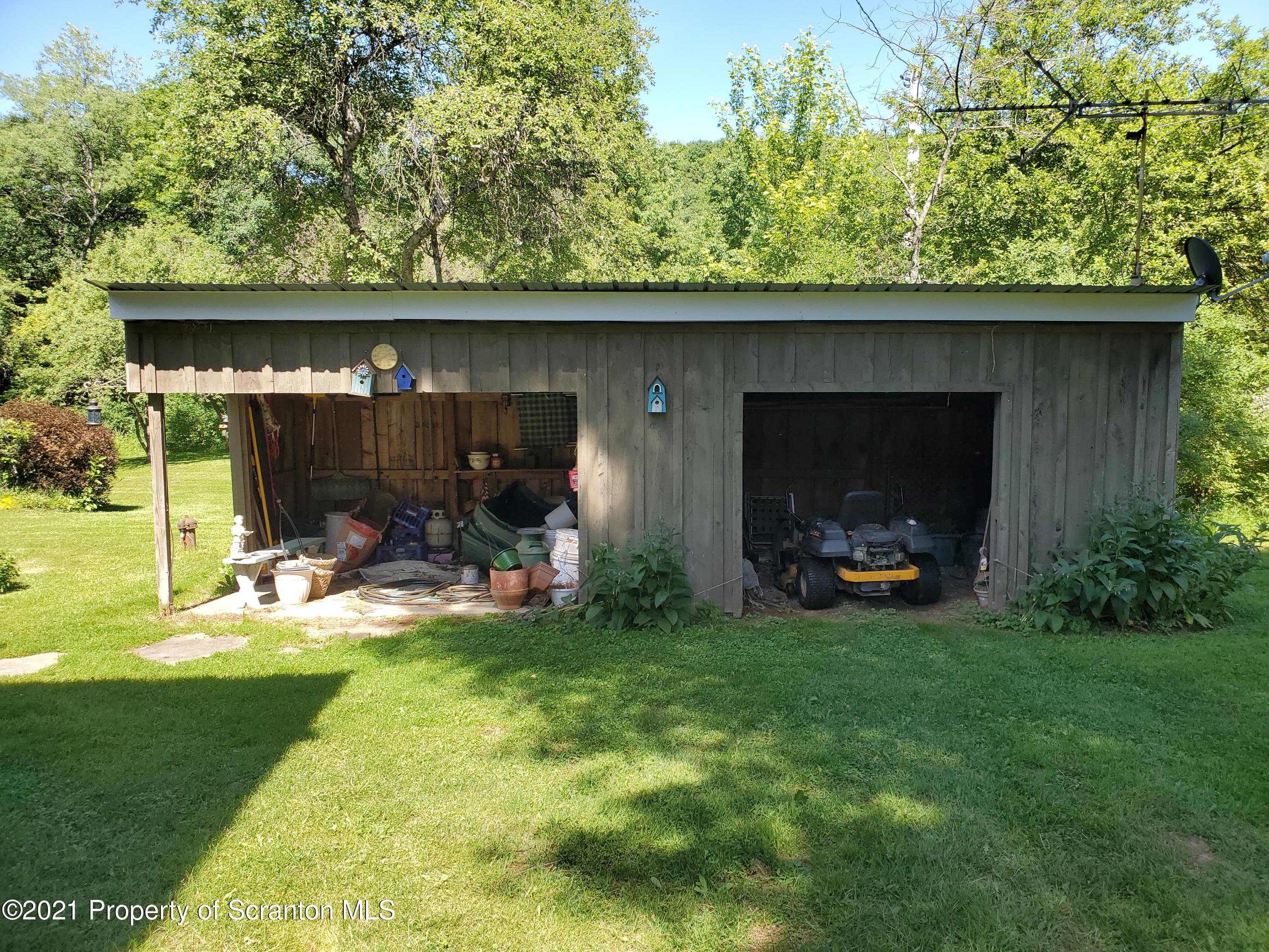1280 Mitchell Road Montrose, PA 18801 - Photo 25 of 28 a view of a garden with a bench in the patio