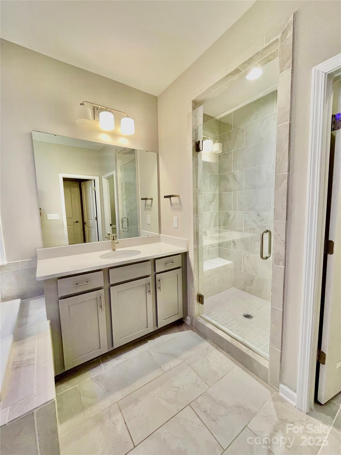 278 West Waterlynn Road Mooresville, NC 28117 - Photo 31 of 46 a bathroom with a granite countertop sink a mirror a bathtub and shower