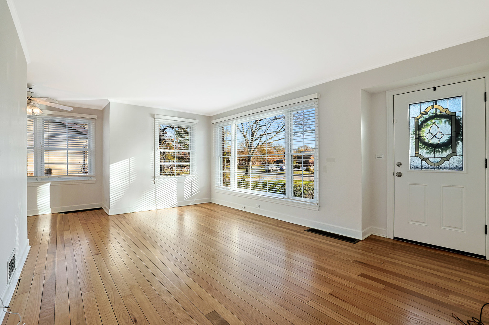 120 South Rohlwing Road Palatine, IL 60074 - Photo 4 of 49 a view of an empty room with wooden floor and a window