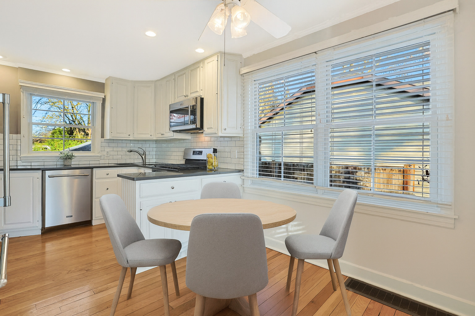 120 South Rohlwing Road Palatine, IL 60074 - Photo 8 of 49 a kitchen with stainless steel appliances granite countertop a stove a sink a microwave refrigerator and a dining table with wooden floor