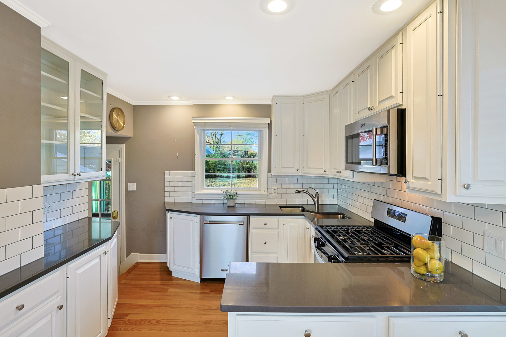 120 South Rohlwing Road Palatine, IL 60074 - Photo 10 of 49 a kitchen with stainless steel appliances granite countertop a sink stove and cabinets