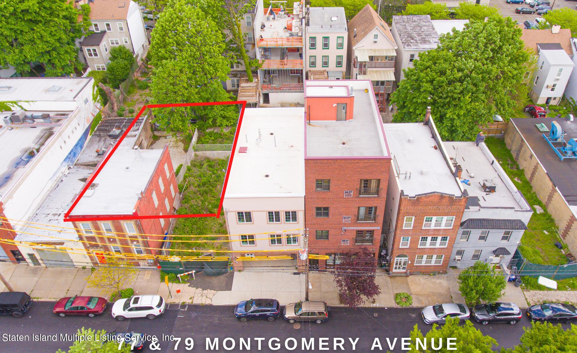 a aerial view of multi story residential apartment building with yard