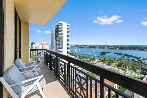 a balcony with table and chairs