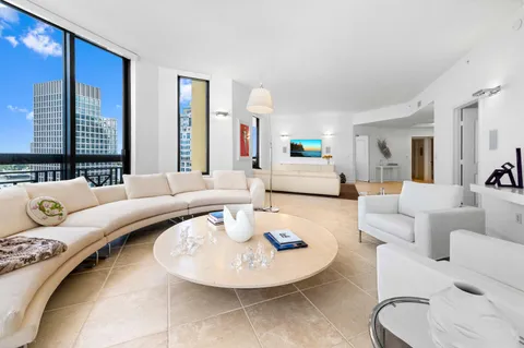 a living room with furniture and a large mirror
