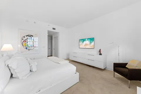 a spacious bathroom with a granite countertop sink mirror and bathtub