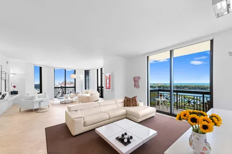 a living room with furniture and a floor to ceiling window