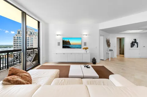 a bed sitting in a bedroom and view of living room