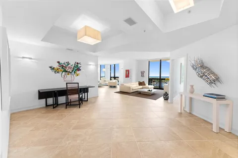 a living room with furniture and a dining table