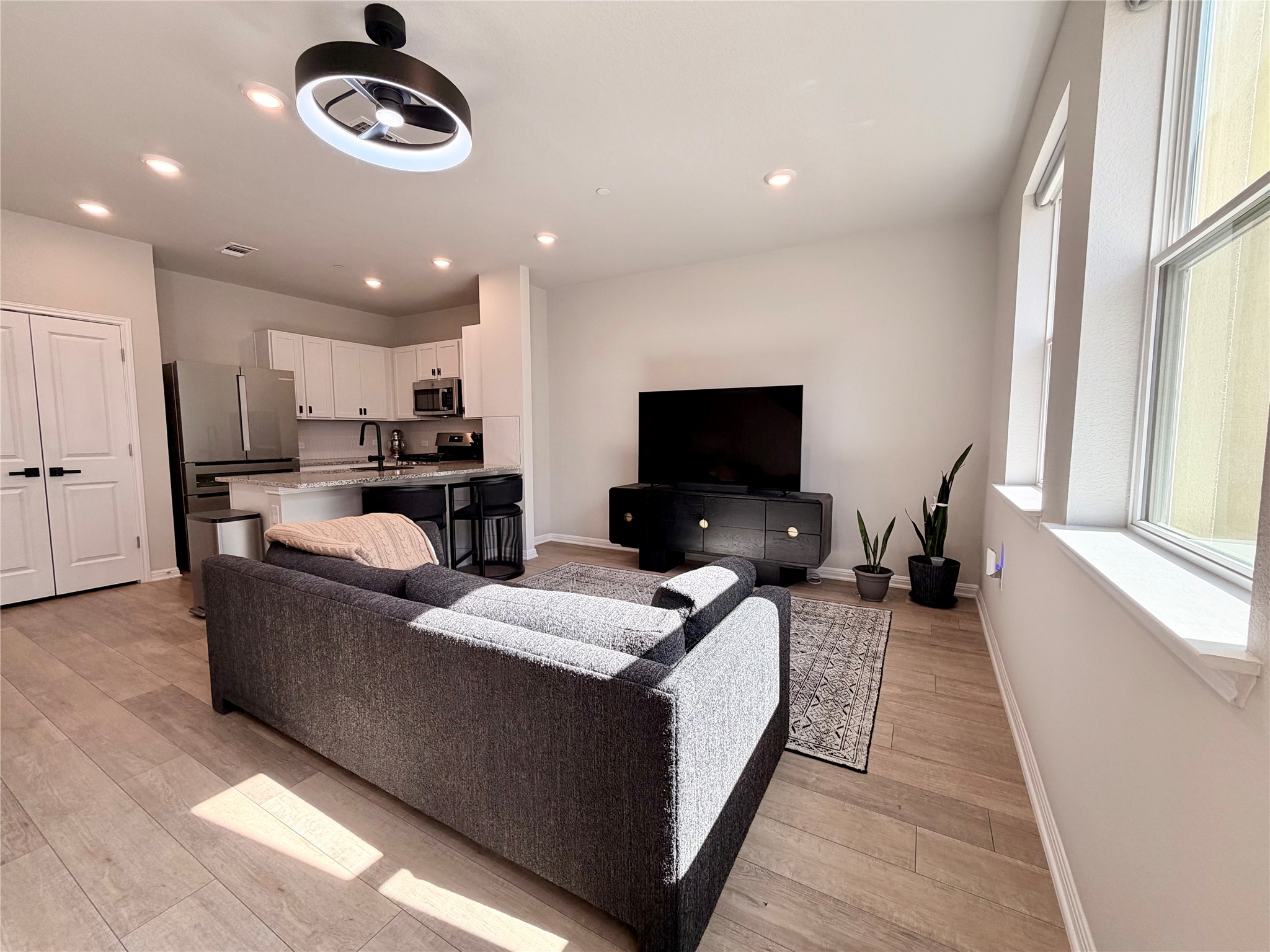 9015 Cattle Baron Path, Unit 1803 Austin, TX 78747 - Photo 3 of 23 Living room with light wood finished floors, a ceiling fan, and recessed lighting