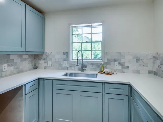 a kitchen with a sink stainless steel appliances and cabinets
