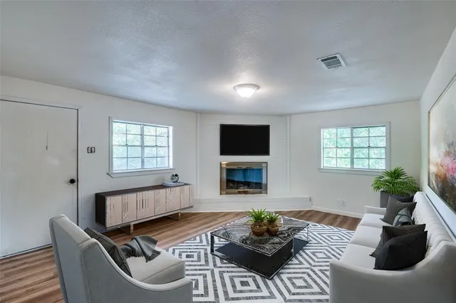 a living room with furniture a fireplace and a flat screen tv